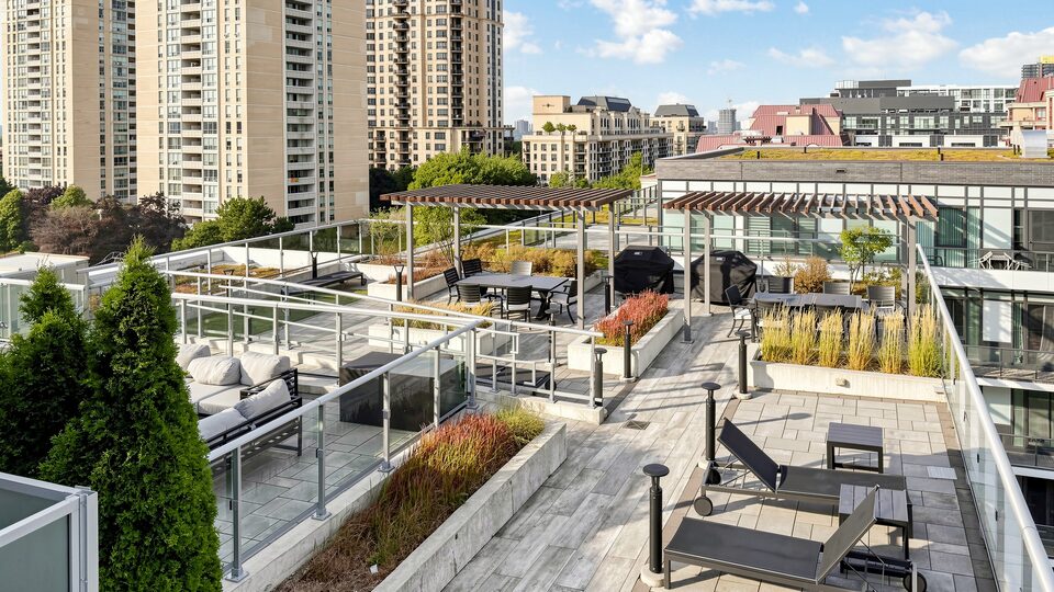 Rooftop garden terrace with pergolas, planters, dining tables and sun loungers