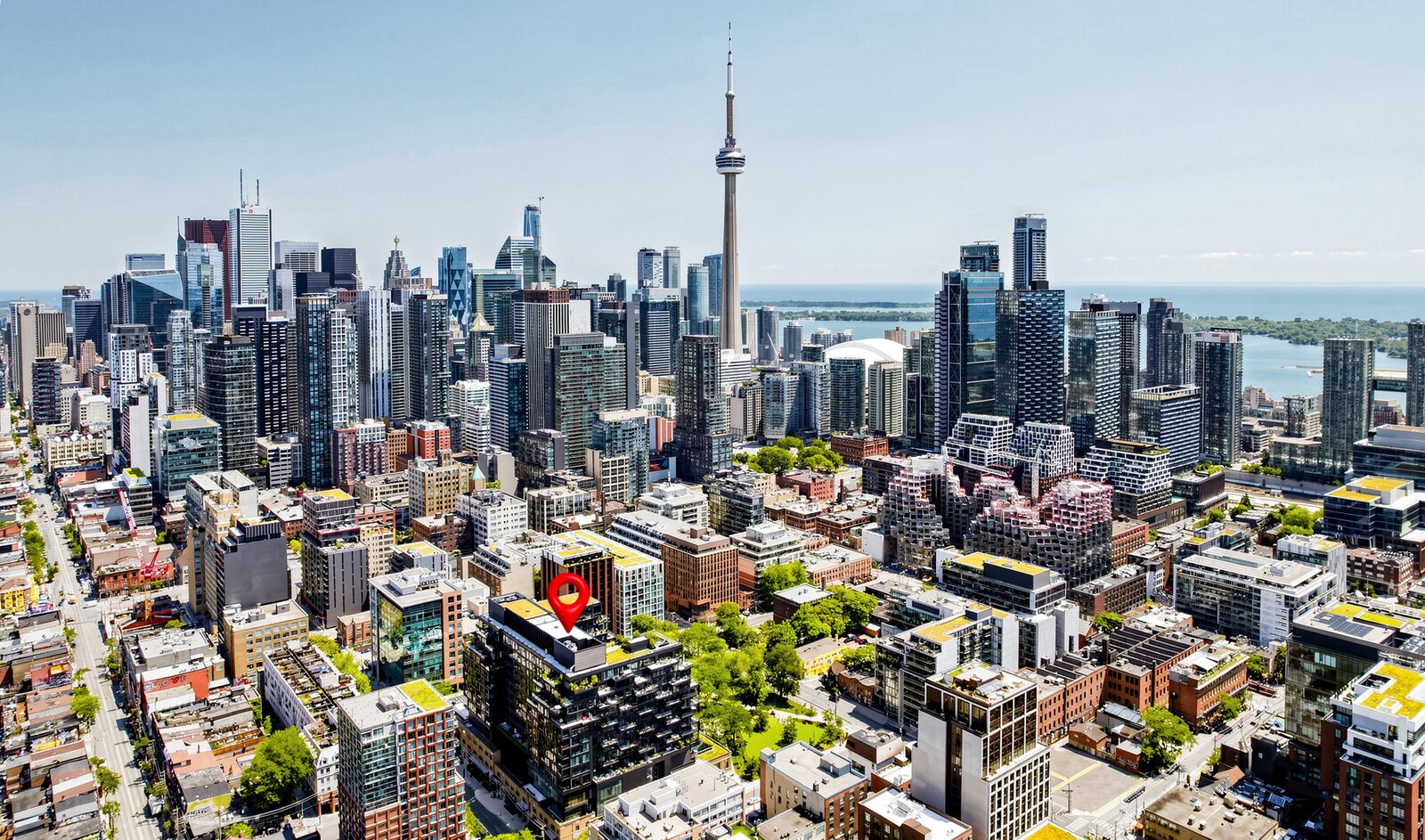 Aerial view of downtown Toronto with the Waterworks Residences marked by a pin in the foreground and the CN Tower behind it